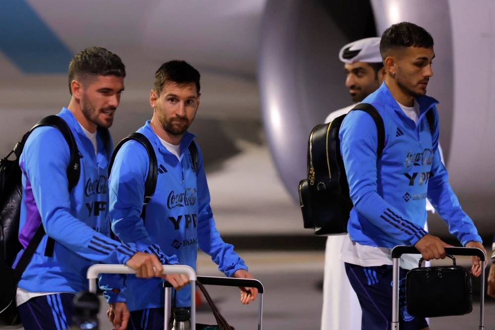 Argentina's forward Lionel Messi and teammates arrive at the Hamad International Airport. (Photo by Odd ANDERSEN / AFP)