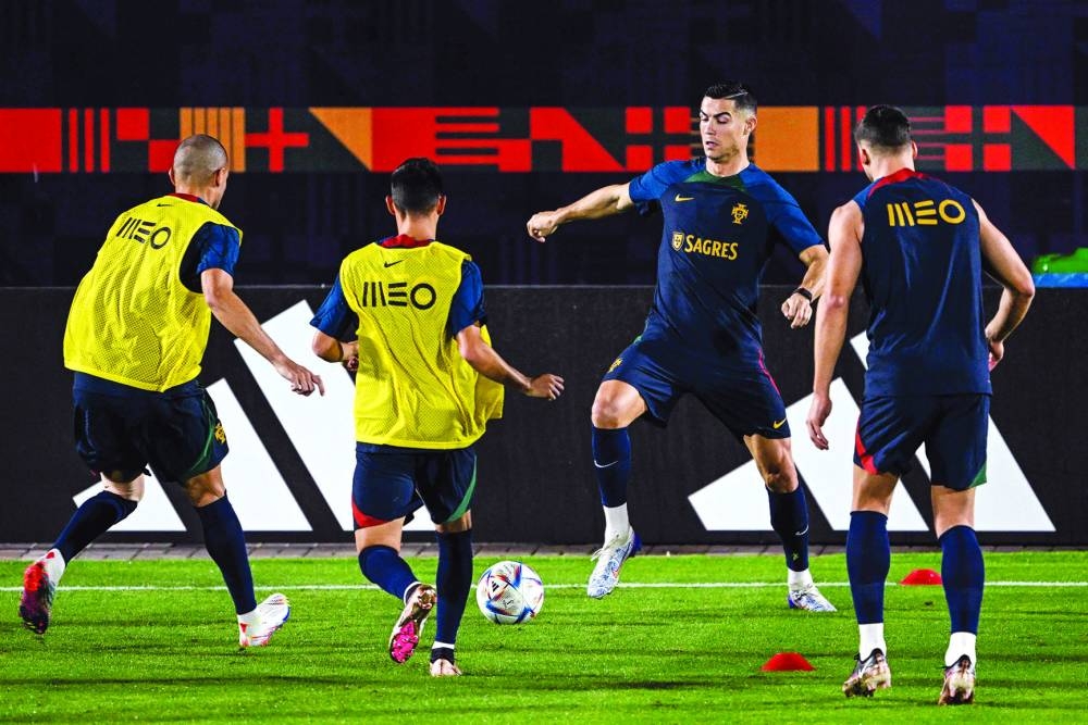 Portugal’s Cristiano Ronaldo (second from right) takes part in a training session alongside teammates at the Shahaniya Sports Club yesterday. (AFP)