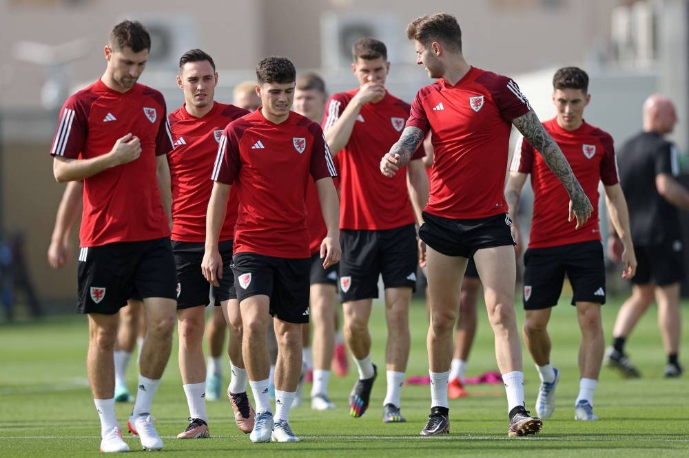 Wales' players walk out for a training session at the Al Saad SC in Doha (AFP).