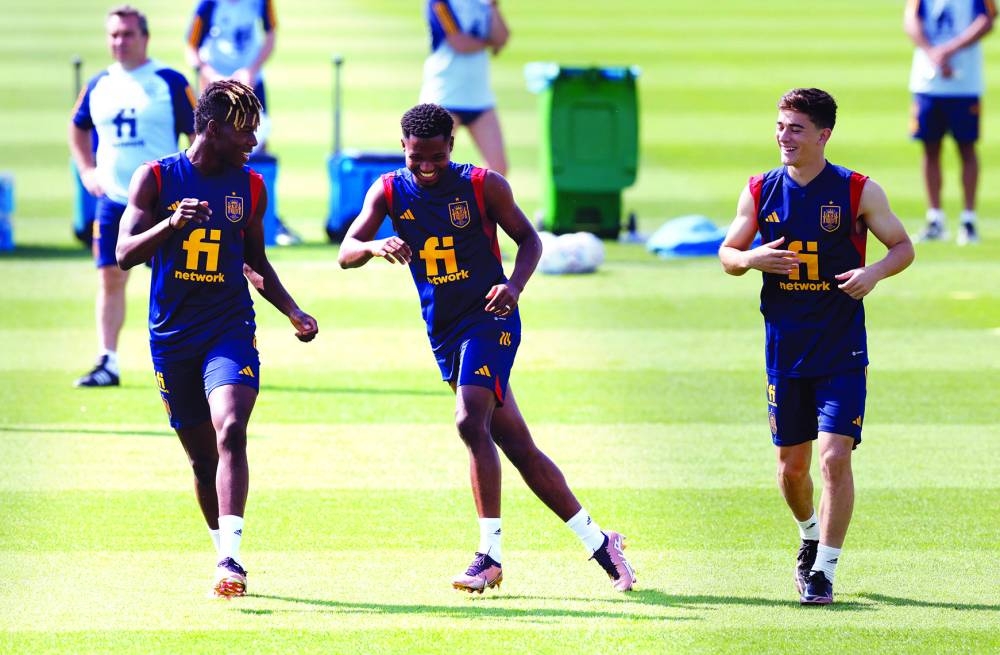 Spain’s Gavi (right), Ansu Fati (centre) and Nico Williams train at the Qatar University training site yesterday. (Reuters)