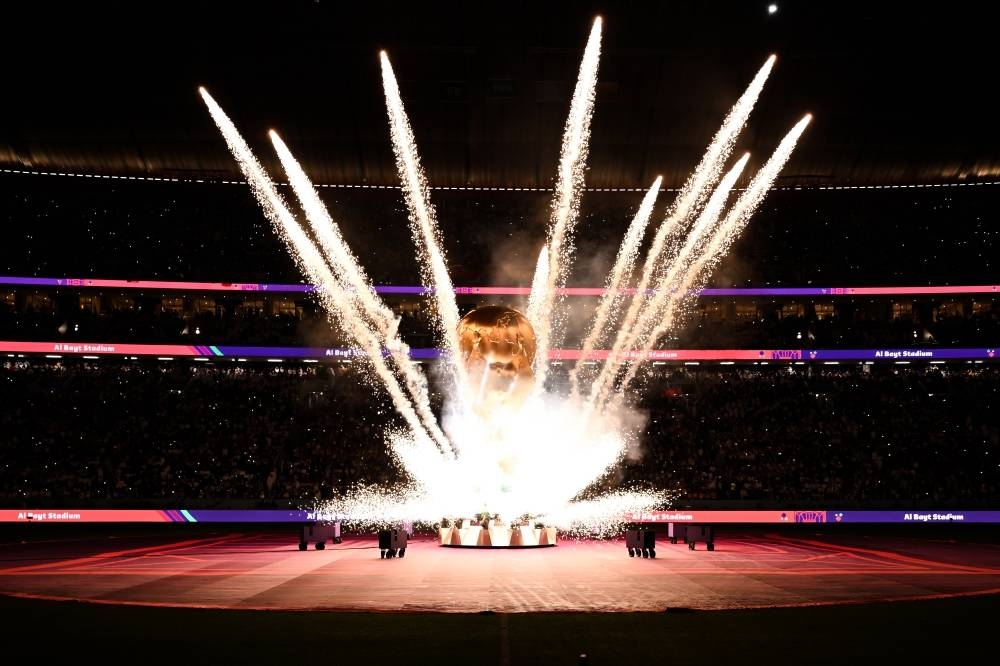 Fireworks surround a large replica of the World Cup trophy before the FIFA World Cup Qatar 2022 Group A match between Qatar and Ecuador at Al Bayt Stadium on November 20, 2022 in Al Khor, Qatar. Photo by Michael Regan - FIFA/FIFA via Getty Images