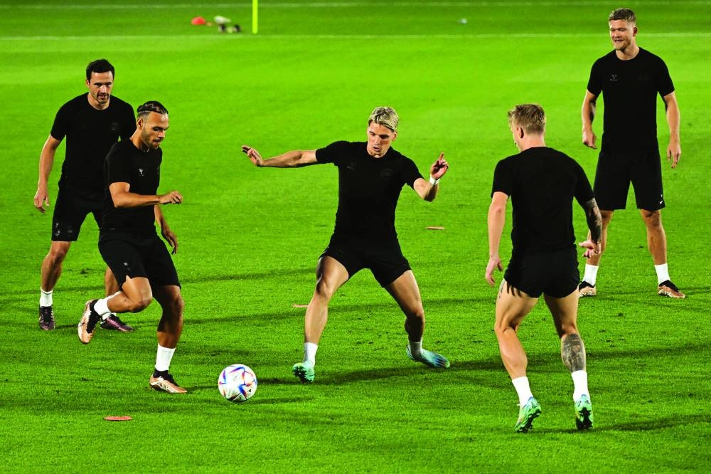 From left: Denmark’s midfielder Thomas Delaney, forward Martin Braithwaite, defender Jens Stryger Larsen, defender Daniel Wass and forward Andreas Cornelius take part in a training session at the Al Sailiya Stadium yesterday.