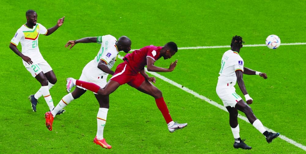 Qatar’s Mohamed Muntari (second right) scores during the FIFA World Cup match against Senegal at the Al Thumama Stadium. (Reuters)