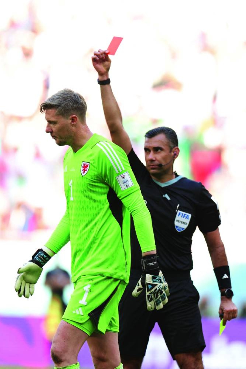 Guatemalan referee Mario Escobar (right) shows a red card to Wales’ goalkeeper Wayne Hennessey during the FIFA World Cup Qatar 2022 Group B match against Iran at the 
Ahmad Bin Ali Stadium in Al Rayyan yesterday. (AFP)