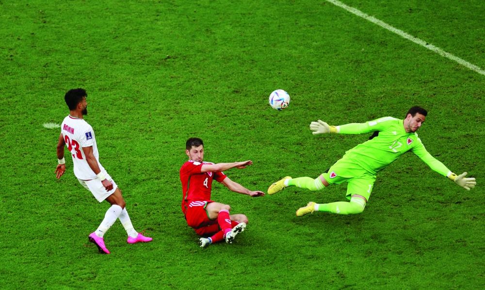 Iran’s Ramin Rezaeian scores their second goal against Wales during the Group B clash at Ahmad Bin Ali Stadium yesterday. (Reuters)