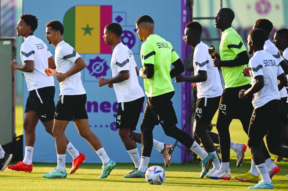 Senegal players jog during a training session at Duhail Handball Sports Hall in Doha yesterday.