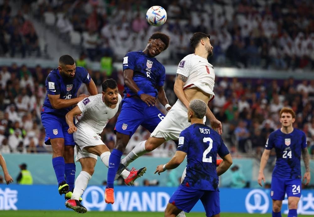 Yunus Musah of the US in action with Iran's Saeid Ezatolahi in the teams' Group B match at the Al Thumama Stadium