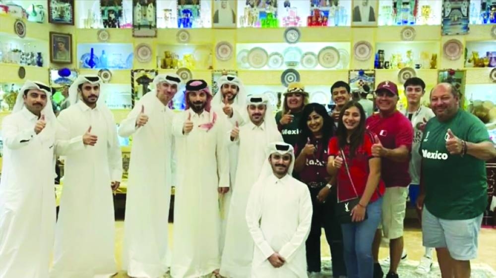 Qatari hosts with a football fans in a majlis.