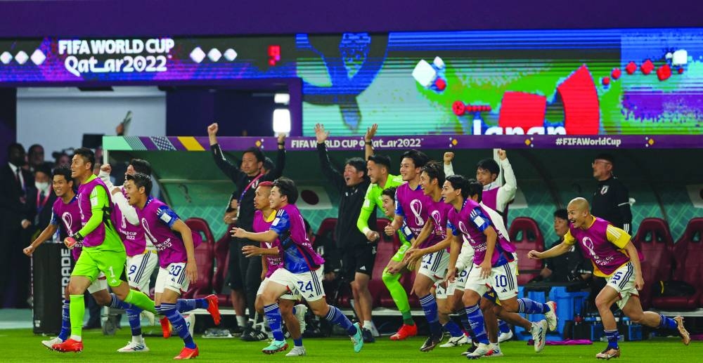 Japan's teammates celebrate after winning the Qatar 2022 World Cup Group E match against Spain at the Khalifa International Stadium in Doha yesterday. (AFP)