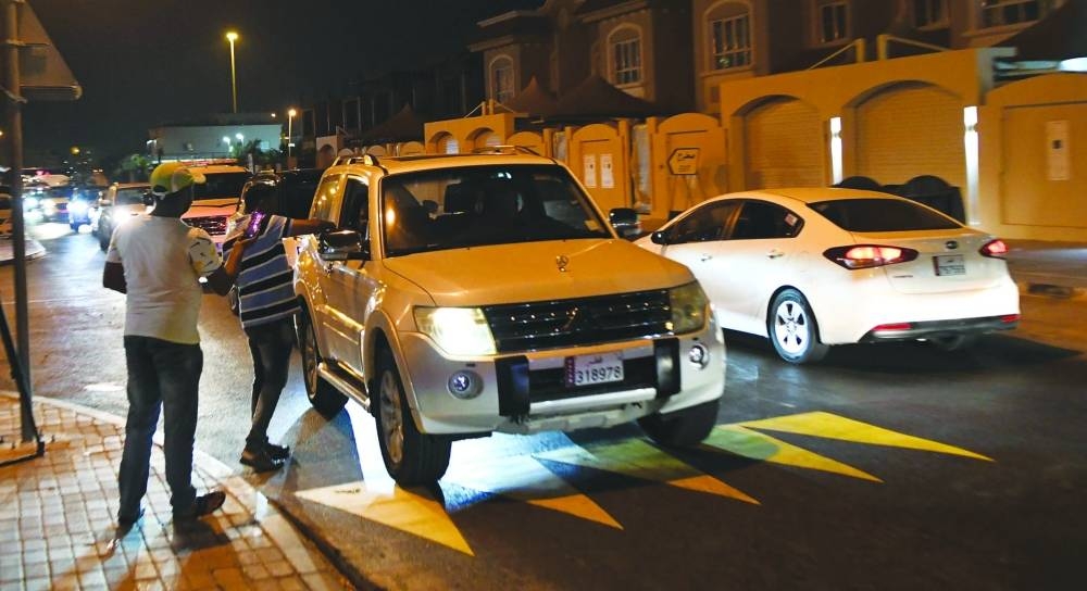 Fans leaving Al Thumama Stadium are offered refreshments by a Qatari household.