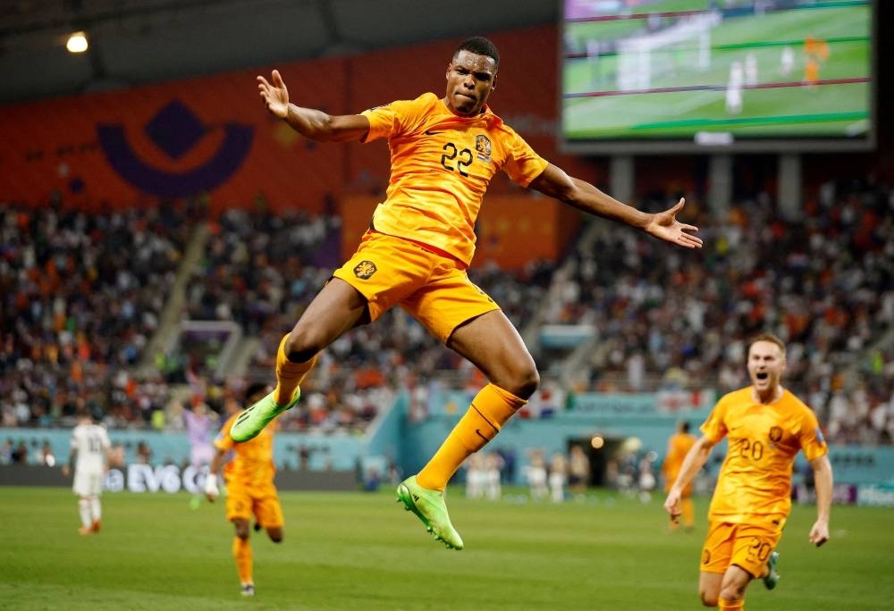 The Netherlands' Denzel Dumfries celebrates scoring their third goal against the US.