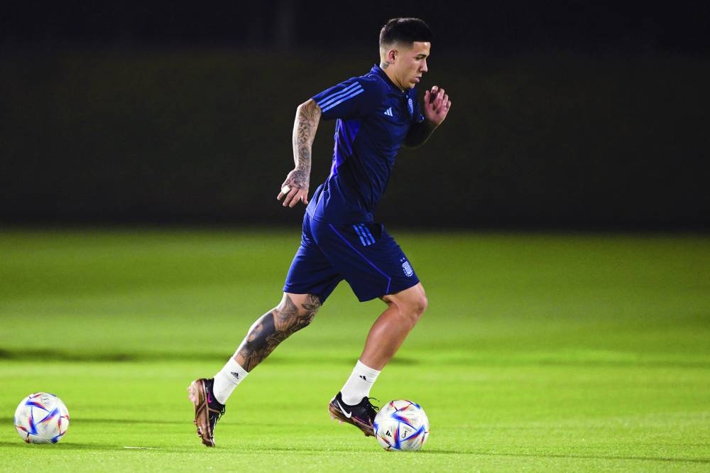 Argentina's midfielder Enzo Fernandez runs with the ball during a training session at Qatar University in Doha on December 2, 2022, on the eve of the Qatar 2022 World Cup football match between Argentina and Australia. (Photo by JUAN MABROMATA / AFP)