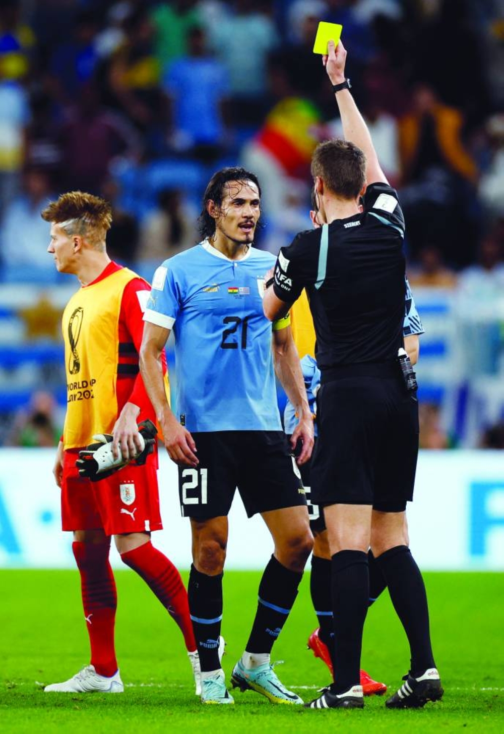 Soccer Football - FIFA World Cup Qatar 2022 - Group H - Ghana v Uruguay - Al Janoub Stadium, Al Wakrah, Qatar - December 2, 2022 Uruguay's Edinson Cavani is shown a yellow card by referee Daniel Siebert REUTERS/John Sibley
