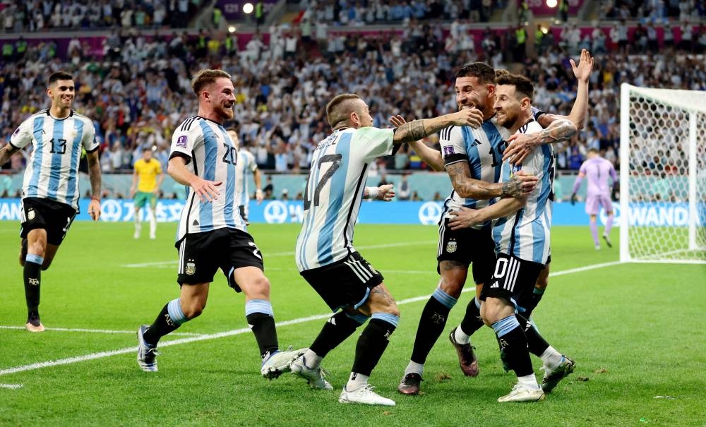 Argentina's Lionel Messi celebrates scoring their first goal with teammates. (Reuters)