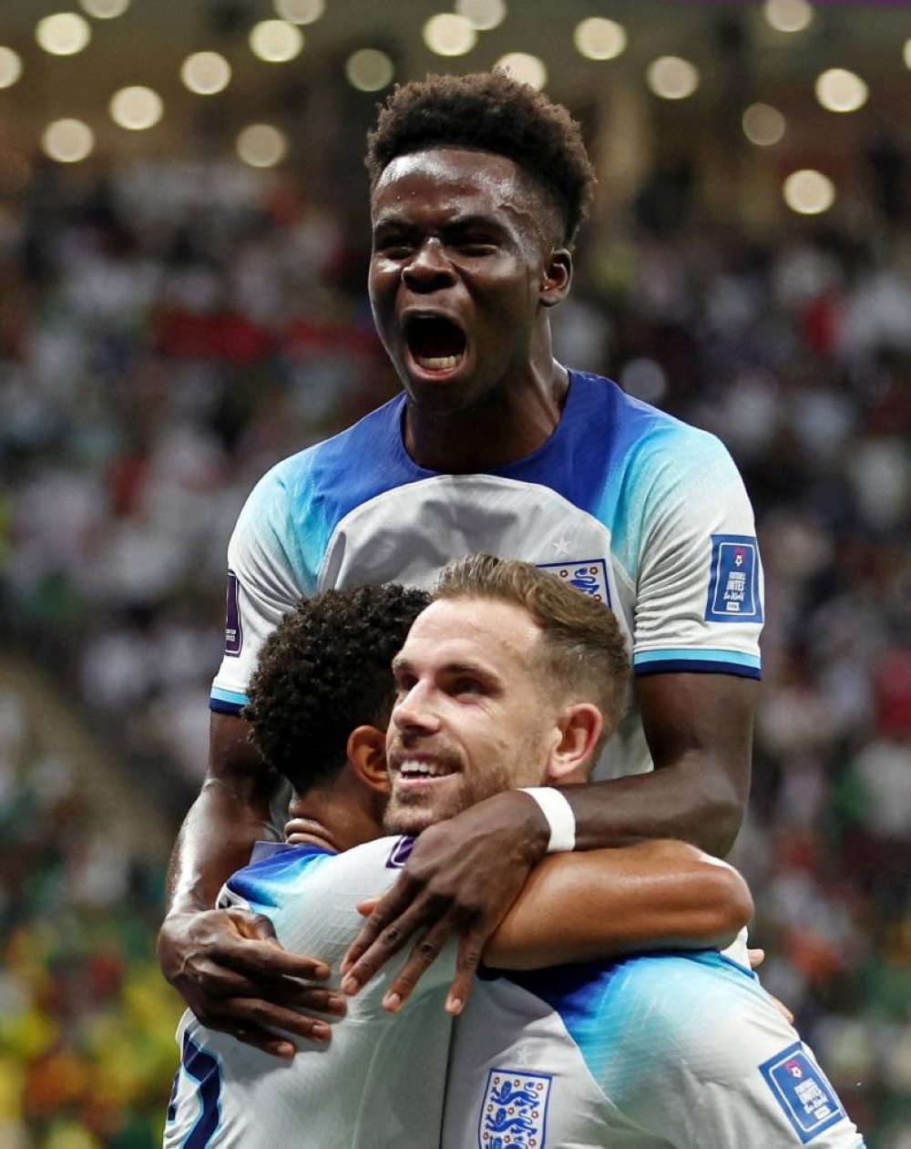 England's Jordan Henderson celebrates scoring their first goal with teammates.