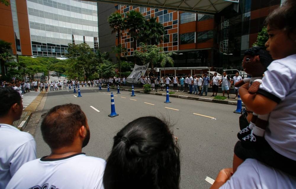 Fans of Santos attend a vigil outside the Albert Einstein Israelite Hospital where Brazilian football legend Pele is hospitalized in Sao Paulo, Brazil, on Sunday. REUTERS