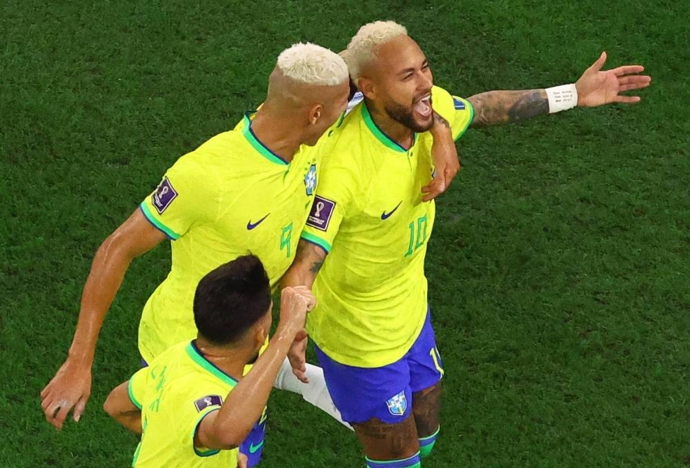 Brazil's Neymar celebrates scoring with Richarlison and Lucas Paqueta