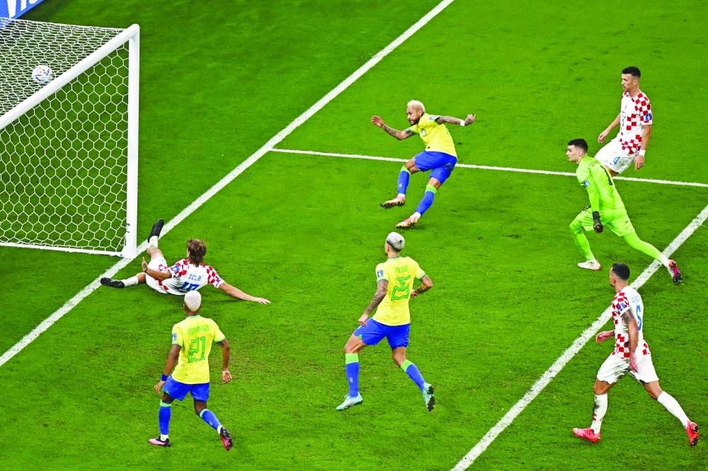 Brazil's forward #10 Neymar (C top) scores his team's first goal during the Qatar 2022 World Cup quarter-final football match between Croatia and Brazil at Education City Stadium.