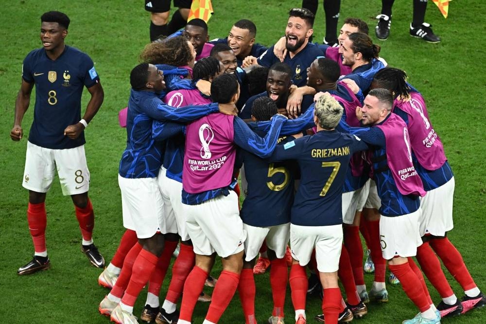 France's players celebrate their win against England.