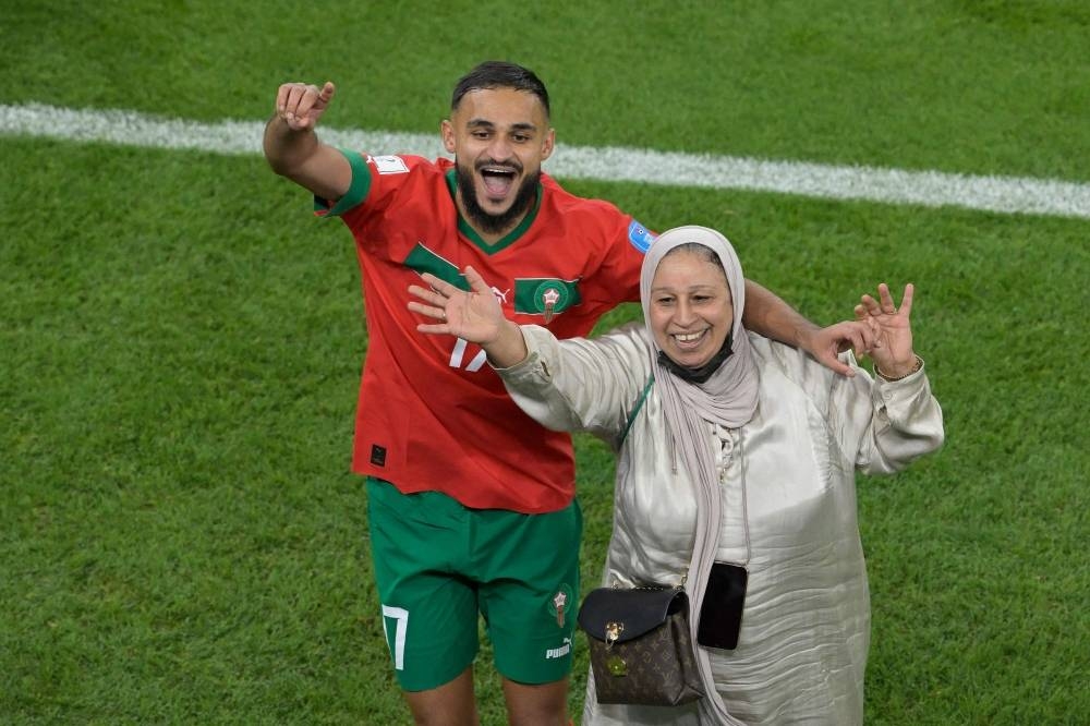 Morocco's Sofiane Boufal celebrates with his mother after defeating Portugal.