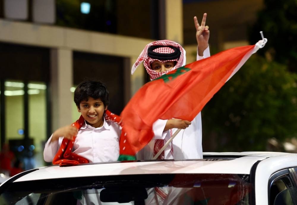 Morocco fans in Souq Waqif, celebrate as Morocco progress to the semi finals after the Morocco and Portugal match. REUTERS