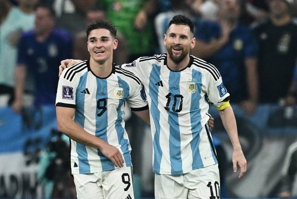 Argentina's Julian Alvarez celebrates scoring the third goal with Lionel Messi.