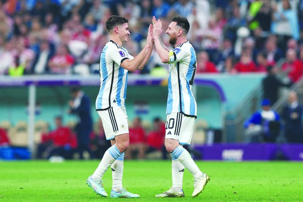 Argentina's forward #09 Julian Alvarez (left) celebrates scoring his team's third goal with Argentina's forward Lionel Messi during the Qatar 2022 World Cup semi-final against Croatia at Lusail Stadium in Lusail on Tuesday. (AFP)