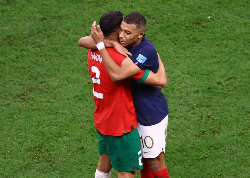 France's Kylian Mbappe consoles Morocco's Achraf Hakimi after the match