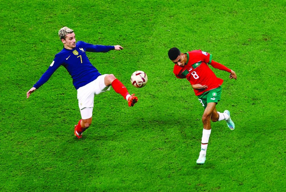     France’s Antoine Griezmann (left) and Morocco’s Azzedine Ounahi vie for the ball during the semi-final of the FIFA World Cup Qatar at the Al Bayt Stadium. (Reuters)


