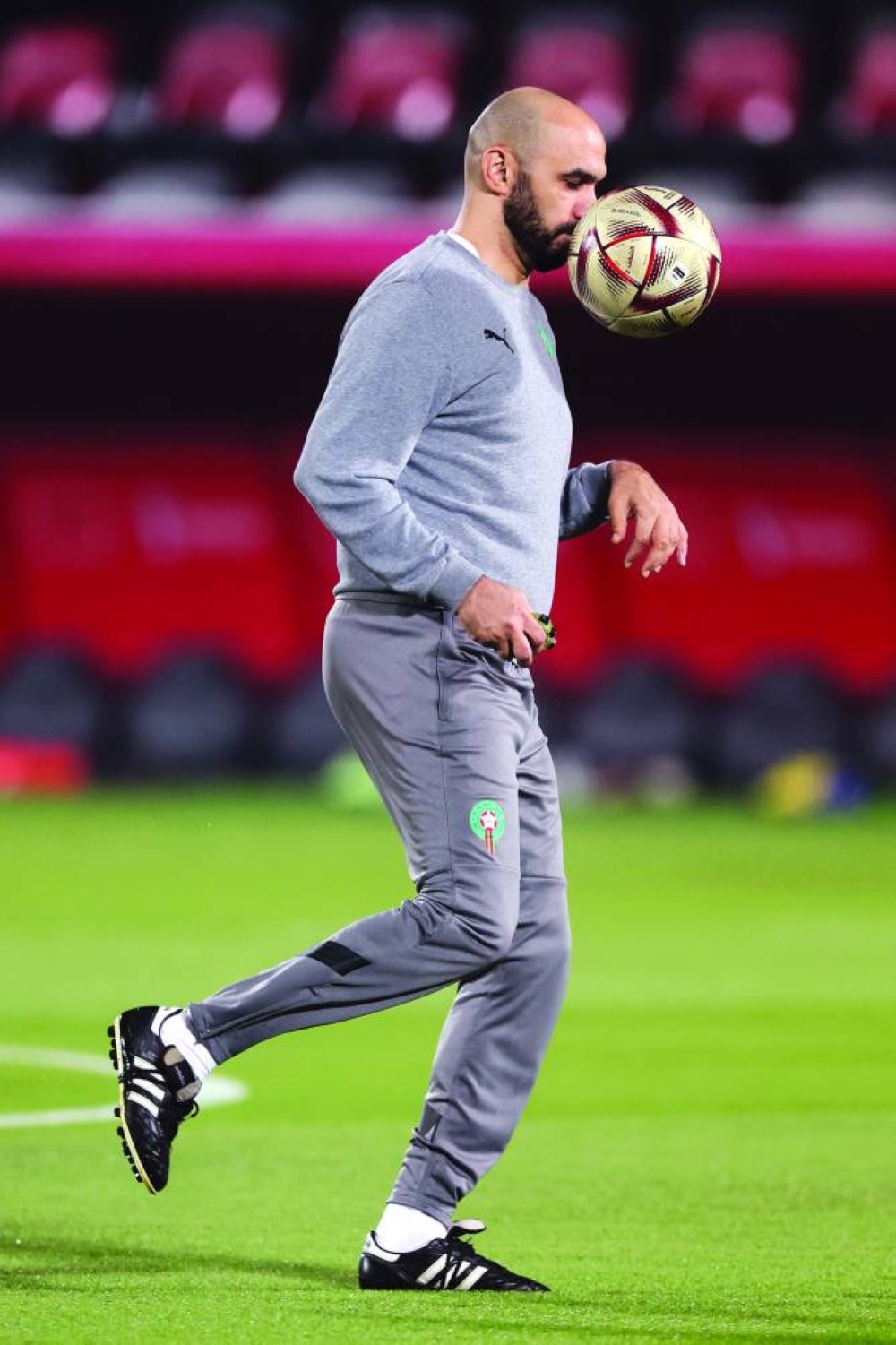 Morocco’s coach Walid Regragui dribbles the ball during a training session at the Al Duhail SC Stadium in Doha yesterday, on the eve of the Qatar 2022 World Cup third place match against Croatia. (AFP)