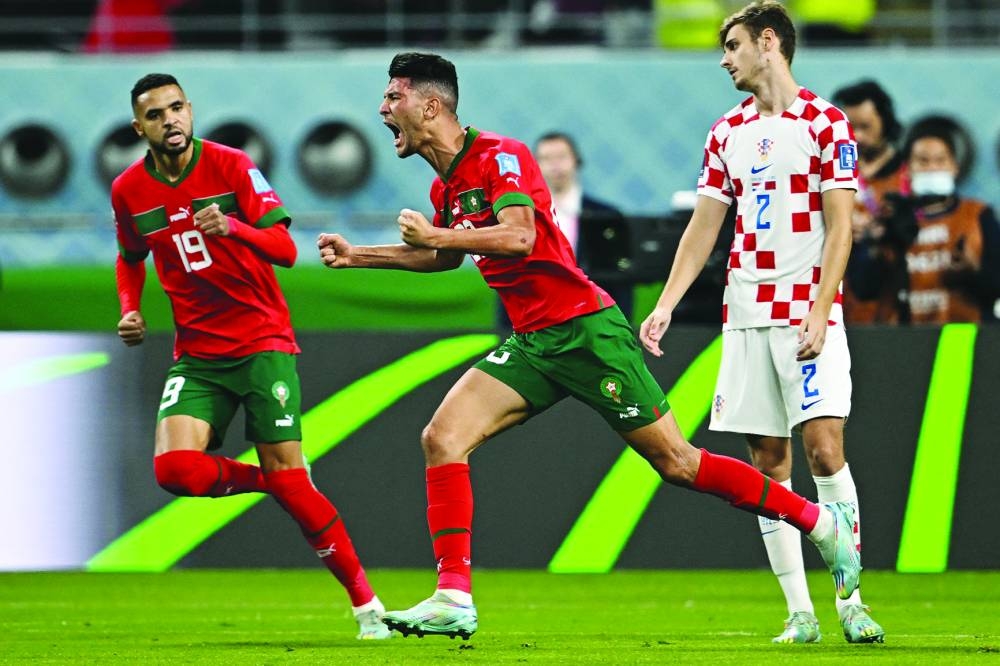 Morocco’s defender Achraf Dari (centre) celebrates after scoring his team’s first goal during the third place play-off match against Croatia played at the Khalifa International Stadium in Doha yesterday.