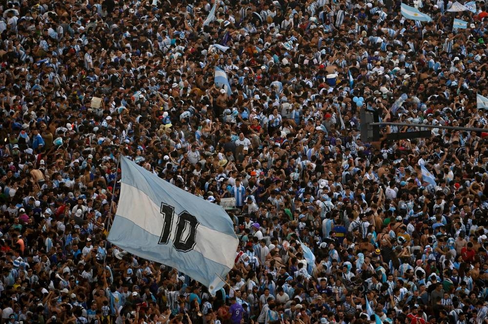 In this aerial view fans of Argentina celebrate winning the Qatar 2022 World Cup against France at the Obelisk in Buenos Aires, on December 18, 2022. (AFP)