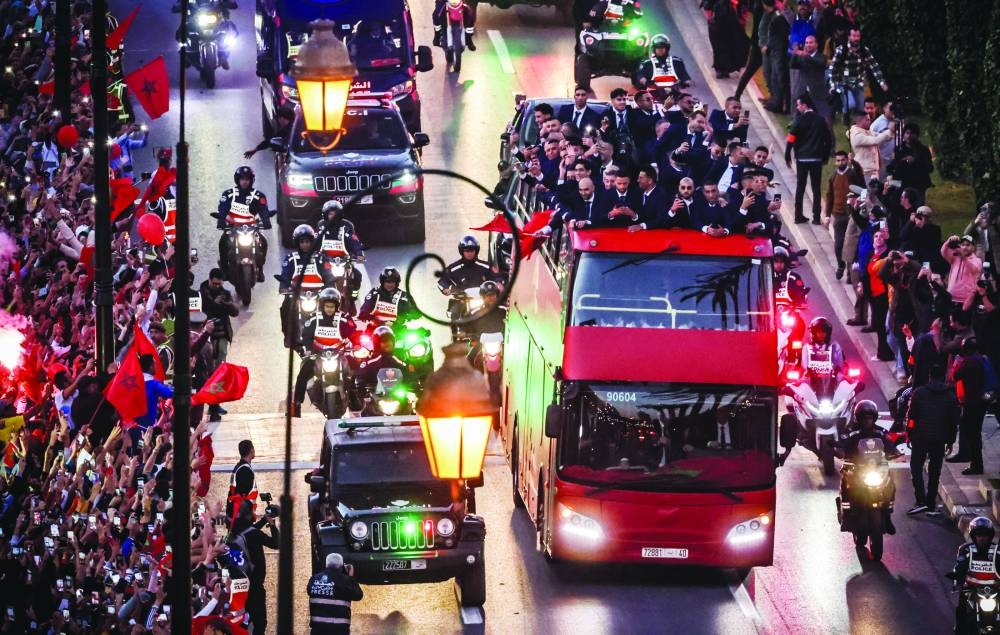Supporters cheer as Morocco's national football team arrives to the center of the capital Rabat after the Qatar 2022 World Cup. (AFP)