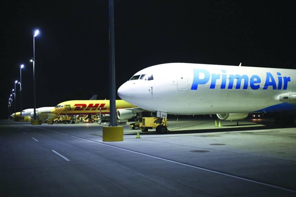 An Amazon.com Prime Air cargo jet sits parked at the DHL Worldwide Express hub of Cincinnati/Northern Kentucky International Airport in Hebron. Amazon is trying to sell excess space on its cargo planes, its latest effort to adjust from a rapid pandemic-era expansion to a slowdown in online growth.
