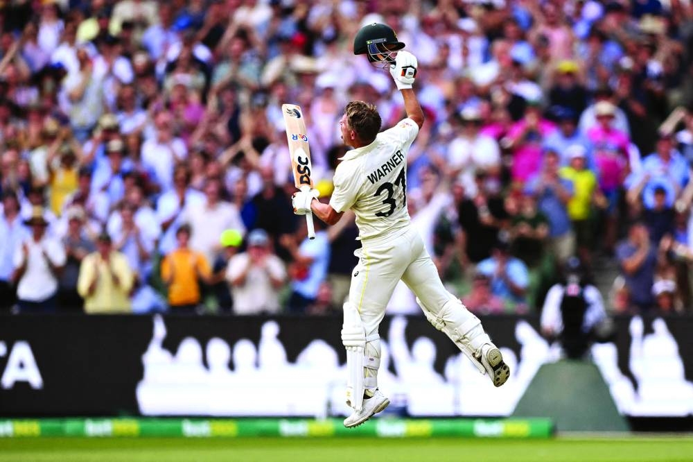 Australian batsman David Warner celebrates scoring his double century on the second day of the second Test against South Africa at the MCG in Melbourne yesterday. (AFP) 