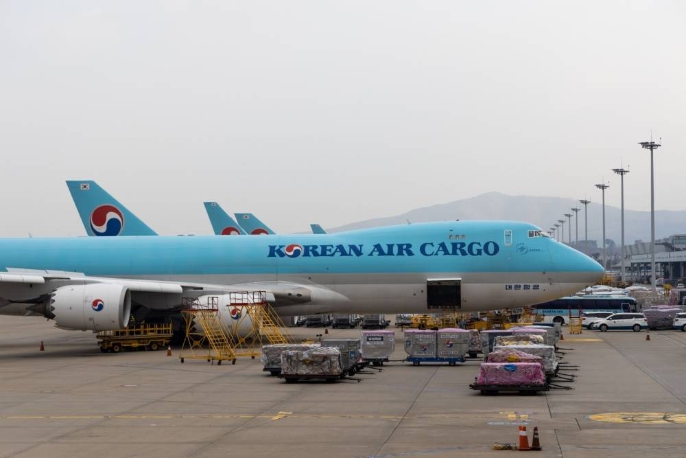 Cargo bound for sits on the tarmac next to Korean Air Lines freight aircraft at the company's cargo terminal in Incheon International Airport in South Korea. High inflation, interest rates and energy costs may put global air freight under mounting pressure in 2023 as headwinds continue to affect air cargo demand.