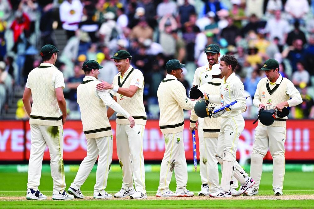The Australian team walks off after defeating South Africa on the fourth day of the second Test at the MCG in Melbourne yesterday. (AFP)