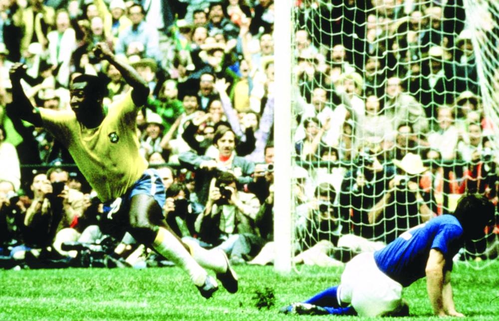 Brazil’s Pele celebrates after scoring the opening goal during the 1970 FIFA World Cup match against Italy at Estadio Azteca in Mexico City on June 21, 1970.