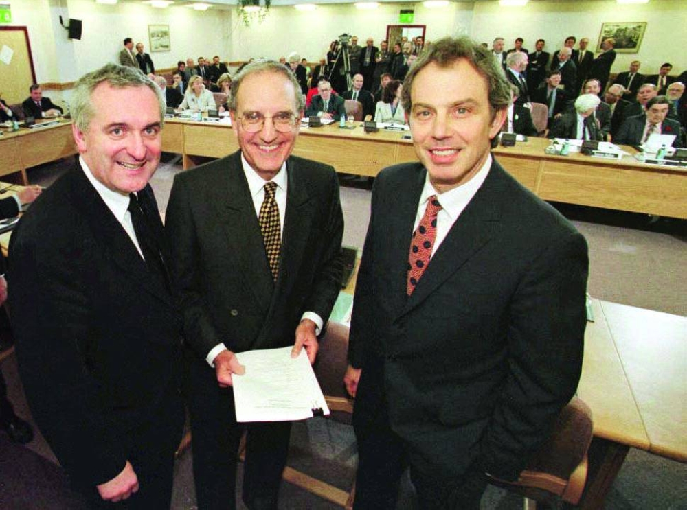 This photo taken on April 10, 1998 shows then-British Prime Minister Tony Blair (right), then-US Senator George Mitchell (centre) and then-Irish Prime Minister Bertie Ahern after they signed a historic agreement for peace in Northern Ireland, ending a 30-year conflict. (AFP)
