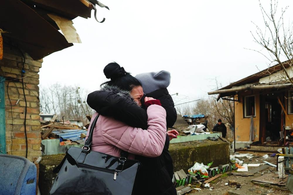 A local resident Yana embraces a friend as she reacts next to her mother's house damaged during a Russian missile strike, amid Russia's attack on Ukraine, in Kyiv, Ukraine December 29, 2022. (REUTERS)