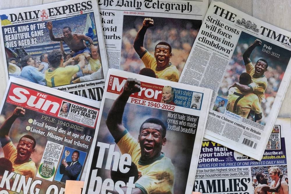 UK daily newspaper front pages photographed as an illustration in London on December 30, 2022, shows headlines reporting on the death of Brazilian football legend Pele, who died on December 29, 2022.