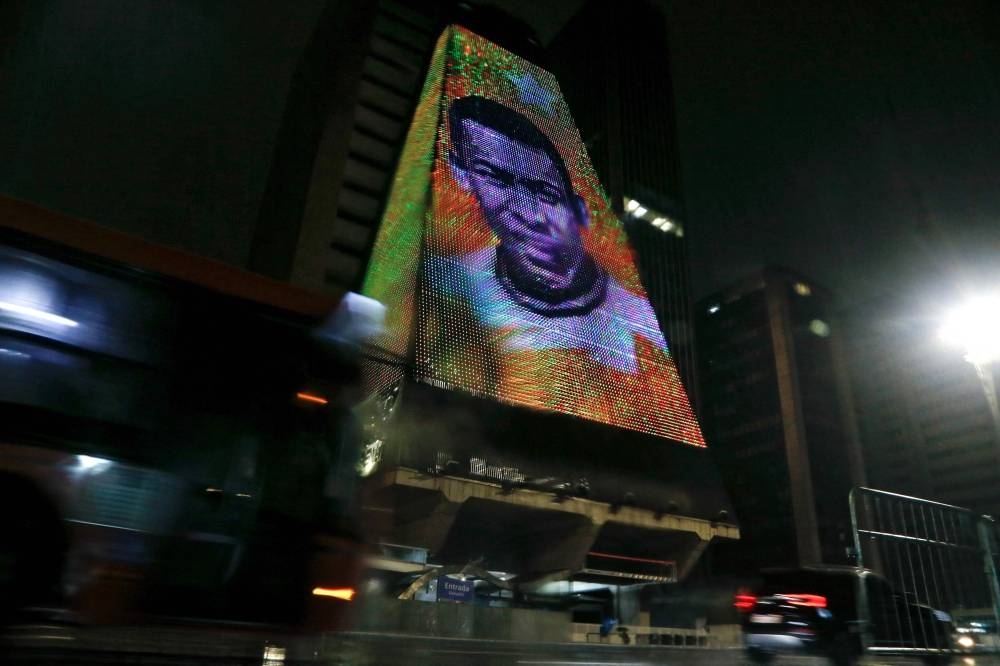 An image of Brazilian football legend Pele, whose death was announced earlier in the day, is displayed at the headquarters of the Federation of the Industries of the State of Sao Paulo (FIESP) in Sao Paulo, Brazil. AFP