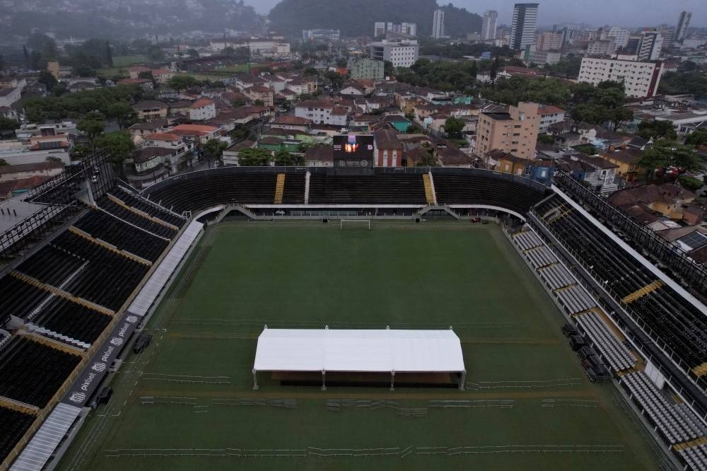 An aerial view shows a tent on the pitch of the Vila Belmiro stadium, home of the Santos FC soccer club where Pele played most of his career, as a crown and text that reads ‘Edson Arantes do Nascimento - 1940 - 2022” is displayed on a screen, in Santos, Brazil. REUTERS