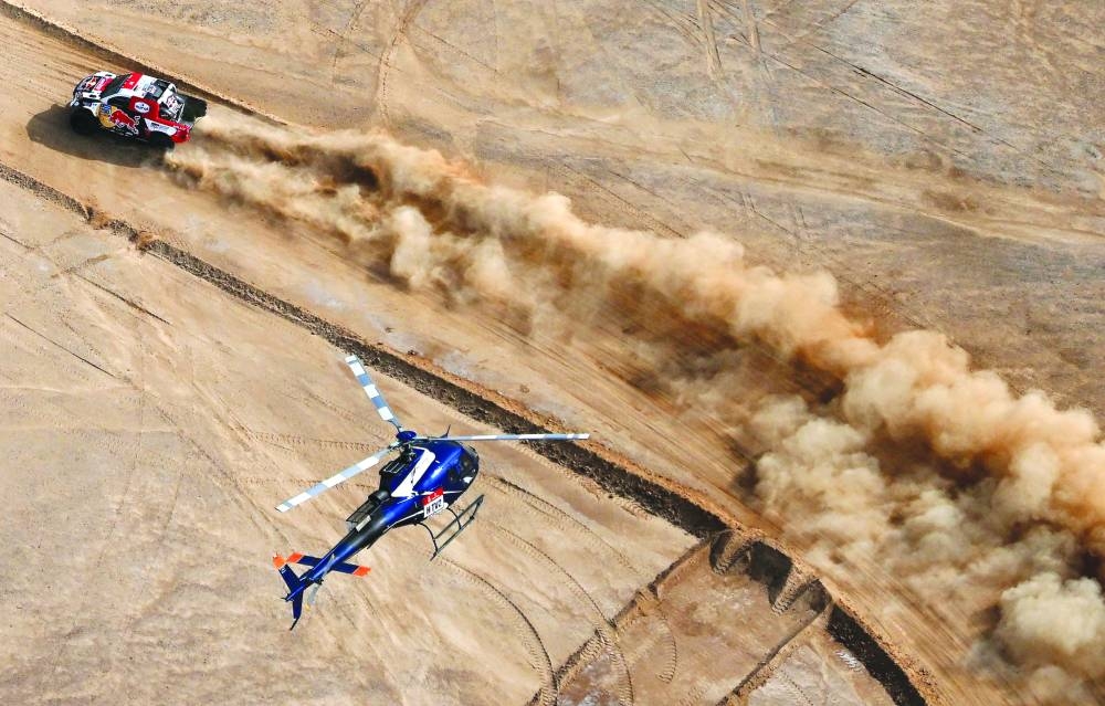 Toyota’s driver Nasser al-Attiyah of Qatar and his co-driver Mathieu Baumel of France  compete during the prologue of the Dakar Rally by the Red Sea in Yanbu, Saudi Arabia, yesterday. (AFP)