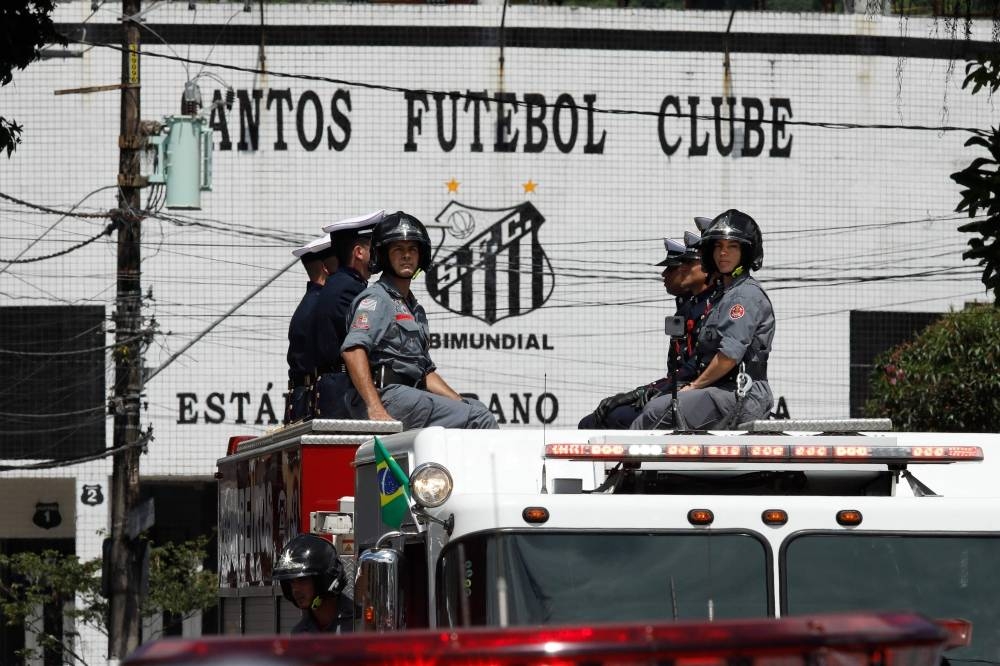 The coffin of the late Brazilian football is transported on a firetruck outside the Urbano Caldeira stadium during a funeral procession to the Santos' Memorial Cemetery in Santos, Sao Paulo state, Brazil on January 3. AFP