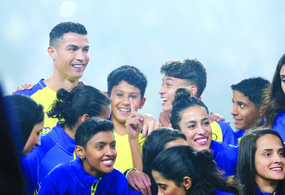 Al-Nassr's new Portuguese forward Cristiano Ronaldo poses for a picture with youths during his unveiling at the Mrsool Park Stadium in Riyadh on Jan 3. Reuters