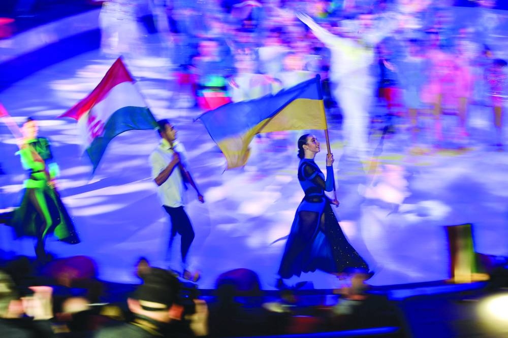 Artists carry the Hungarian and Ukrainian flags during the Yaskrava Arena Dnipro International Children’s Circus Festival in Budapest.