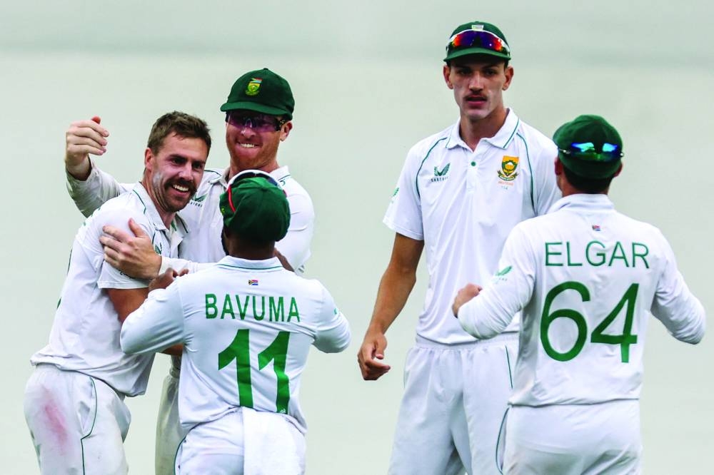 South Africa’s Anrich Nortje celebrates with teammates after dismissing Australia’s Marnus Labuschagne during the third Test in Sydney yesterday. (AFP)