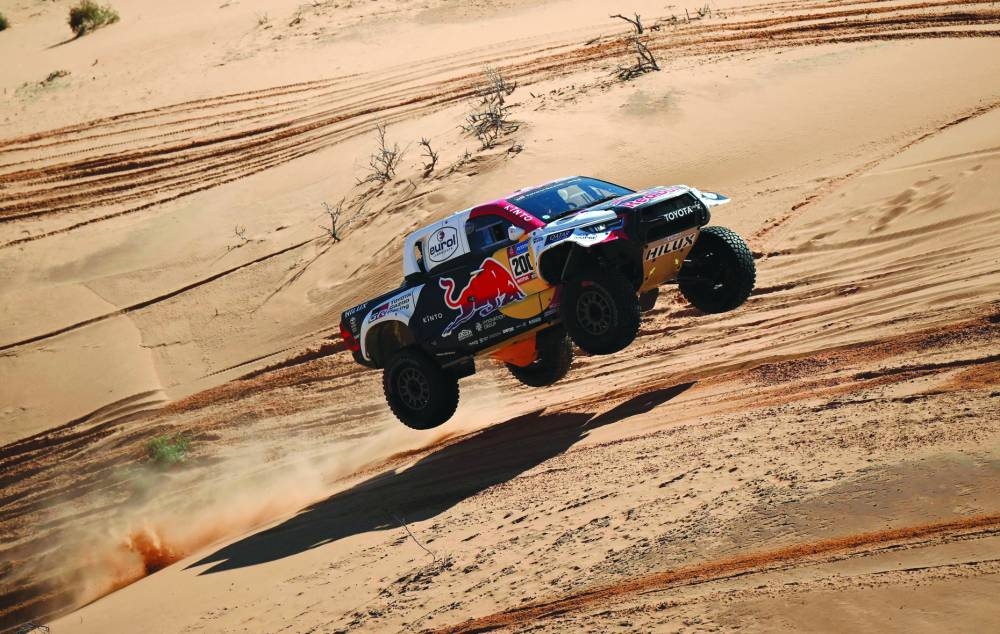     Toyota’s Qatari driver Nasser al-Attiyah and his French co-driver Mathieu Baumel compete during the fifth stage of the Dakar Rally around Ha’il in Saudi Arabia on Thursday. (AFP)


