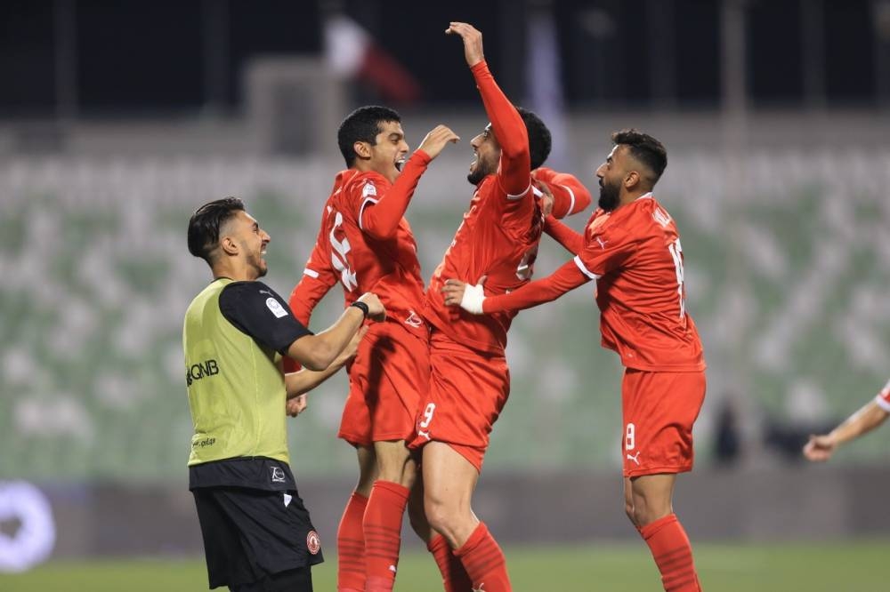 Al Arabi's Omar al-Somah celebrates with teammates after scoring against Al Ahli in the QNB Stars League at Hamad Bin Khalifa Stadium on Thursday.